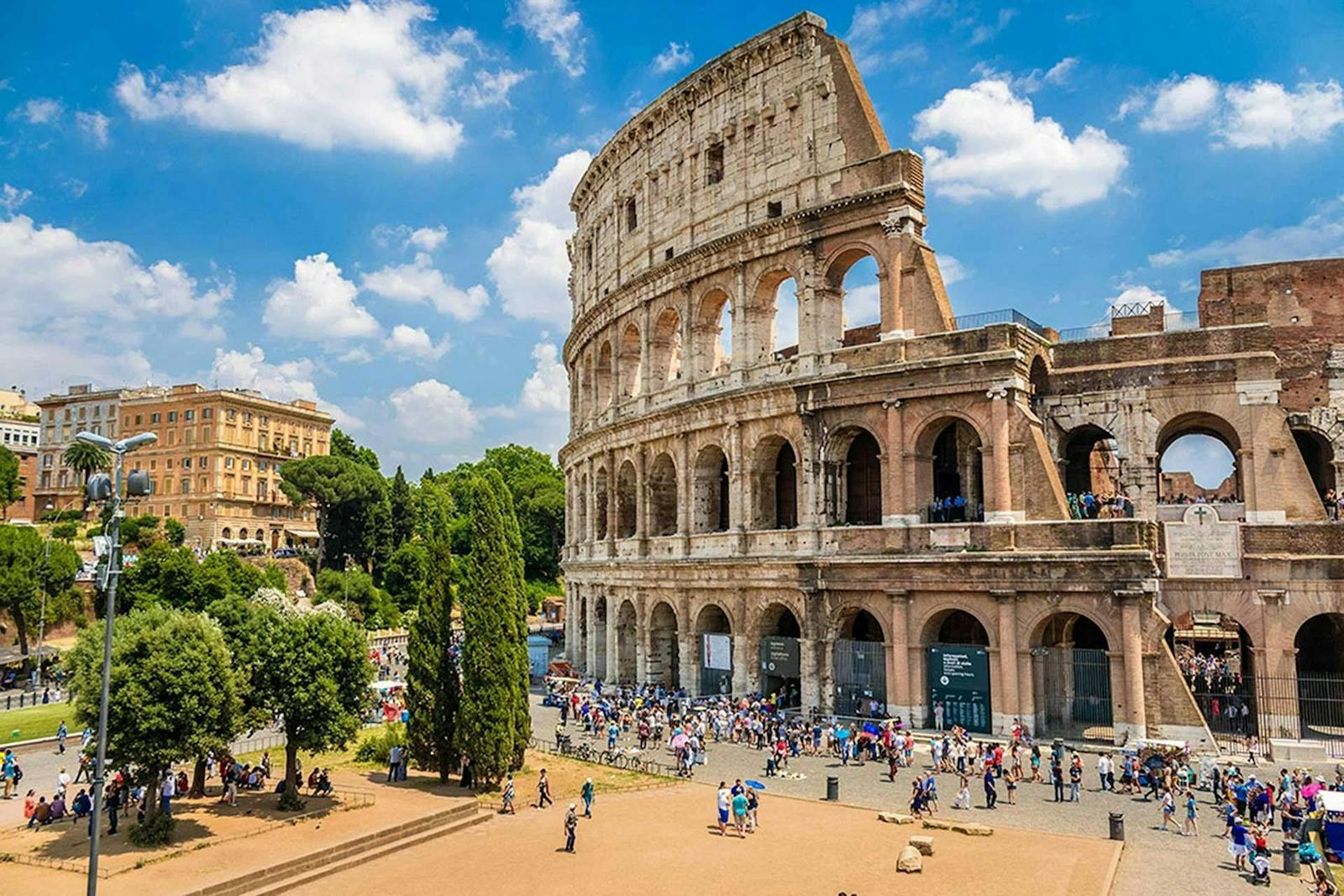 Exterior view of the Colosseum under a blue sky