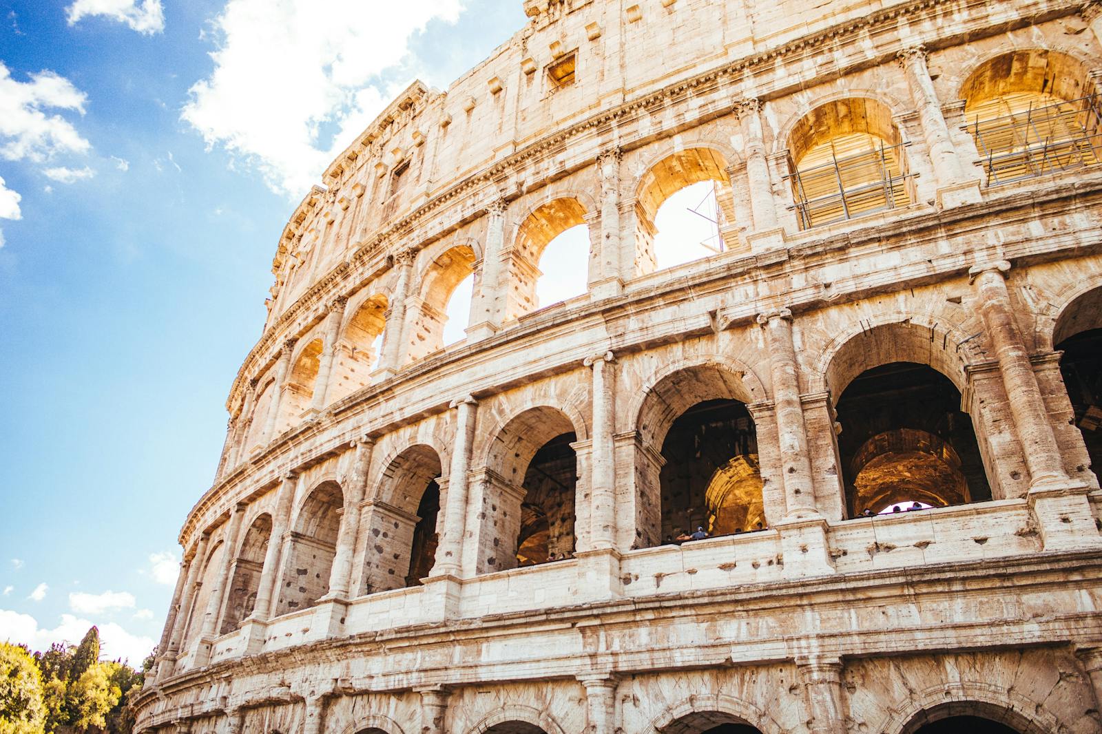 Low-angle view of the Colosseum under a blue sky