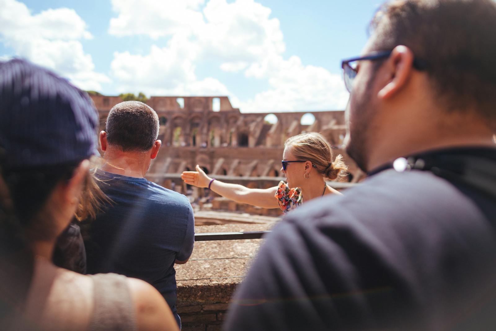 Tour guide explaining the history of the Colosseum to visitors